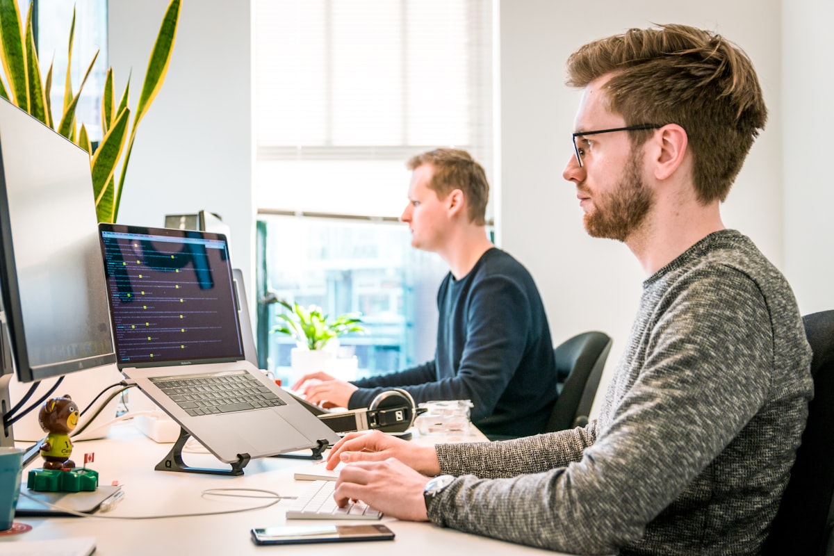 Software developer coding in an office workspace